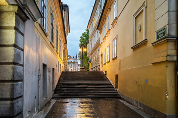 Fototapeta premium A narrow stairway in the old town, often referred to as Gledališka stolba or Theater Stairs, connecting the Kongresni trg (Congress Square) to the Ljubljanica River embankment, Ljubljana Slovenia.