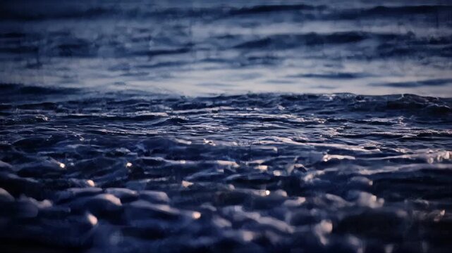 A dark, moody ocean wave crashes with foamy white crests under a shadowy sky