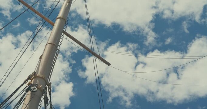 Sailboat Mast and Rigging Against Cloudy Sky