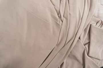 Obraz premium Smooth light brown fabric with soft folds and texture.