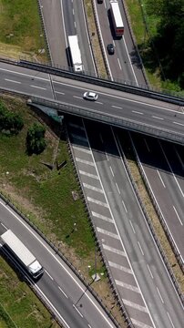 Highway Interchange Aerial View: An aerial perspective captures the complex network of a highway interchange with vehicles navigating the elevated roads and on-ramps.