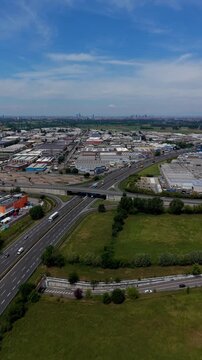 Highway Junction in Industrial Area: An aerial view shows a bustling highway junction cutting through a vast industrial zone.