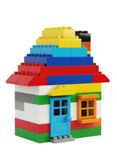 Naklejka premium miniature dwelling constructed from glossy, vibrant, interlocking plastic toy bricks (red, white, green, orange), isolated on a brilliant white studio background. concept of home ownership and
