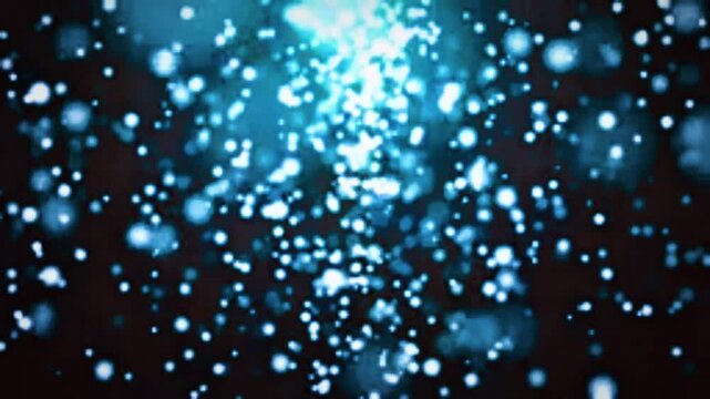 Abstract macro animation of glowing blue and white bokeh particles falling down from a bright light source on a dark background, soft loop effect.