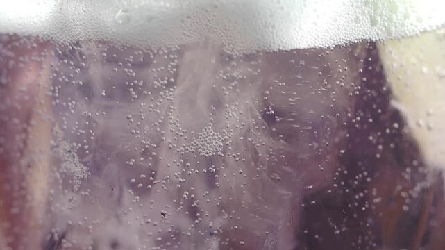 Bubbles rising in a clear drink on a sunny day