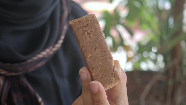 Close-up of Hand Holding a Healthy Snack Bar