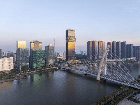Aerial view of the modern Thu Thiem 2 Bridge spanning the Saigon River with the urban skyline and skyscrapers under a clear sky in Ho Chi Minh City, Ho Chi Minh, Vietnam.