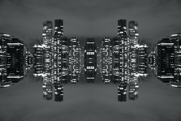 Black and white mirror-image photo of a modern city with high-rise buildings at night. © Hamilton Productions