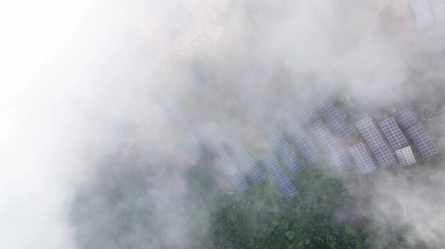 Aerial view of city buildings shrouded in thick fog and clouds