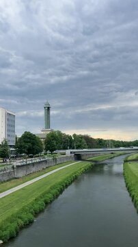 View of the New City Hall Tower on a sunny day across the Ostravice River. Scenic urban landscape of Ostrava with clear sky and riverside atmosphere, perfect for travel, architecture, and city 