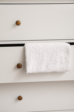 White chest of drawers with towel, closeup