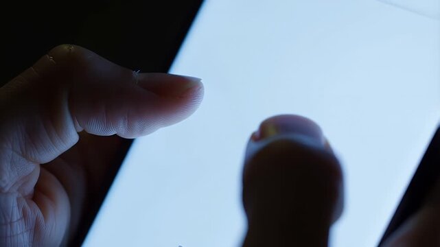 Close Up of Fingers Scrolling on Blank Glowing Smartphone Screen at Night