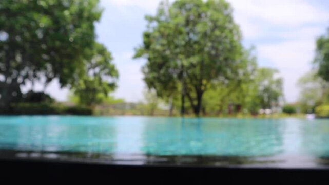 Abstract blur outdoor swimming pool in tropical resort hotel summer background