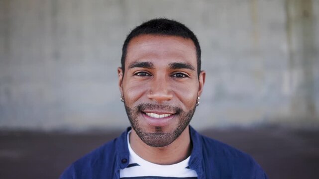 Happy Latin man smiling in front of camera - Young male lifestyle concept
