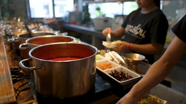 Asian Woman Serving Northern Thai Curry Soup in a Street Food Restaurant