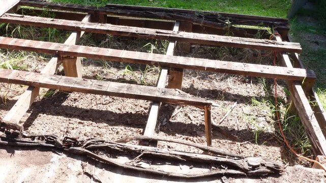 Rotted wood deck boards decayed timber caused by fungi thriving in damp conditions, represent a significant structural risk, house renovations project.
