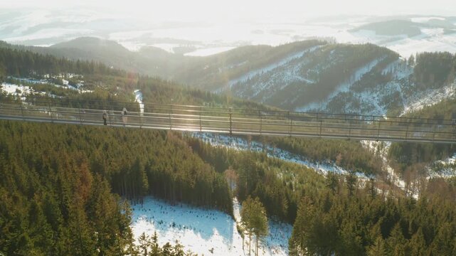 Sky Bridge 721 suspension footbridge connecting two hills above a forest landscape in Dolni Morava, Czech Republic. Concept of tourism and outdoor exploration.