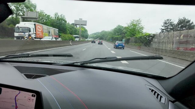 Dashboard View of Car Driving on Paris Highway with Windshield Wipers