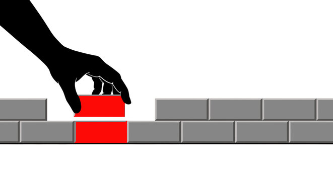 Hand Placing Red Brick in Grey Wall Construction