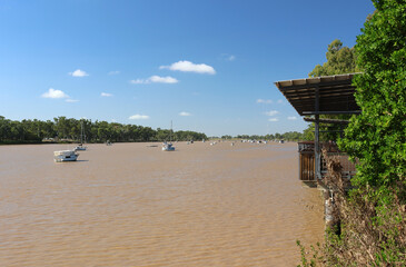 Boats and yachts anchored on the wide, brown waters of the Fitzroy River in Rockhampton, Queensland, Australia © Tammy Walker