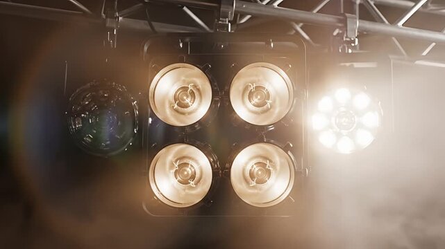 Stage Lights Illuminate Concert Venue with Warm Ambiance.