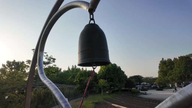 Slow motion view of the romantic Lovers' Bell silhouette at Kasumigaura Sogo Park at dusk