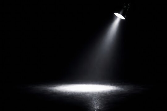 un foco de luz iluminando una habitaci&oacute;n a oscuras