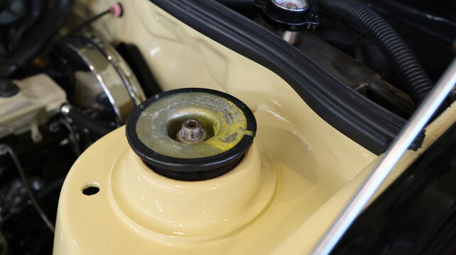 Close up of a car suspension strut tower and mount in a clean engine bay