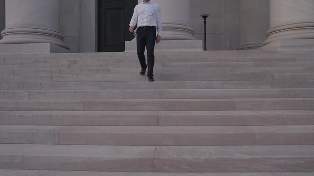 Business man walking stairs as a step toward success. Businessman climbing stairs counting every step. Business man taking the next step in his career. Businessman moving one more step upward.