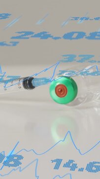 Vertical video: Syringe vial shifting right after cam nudge while blue graphs sweeping to show data