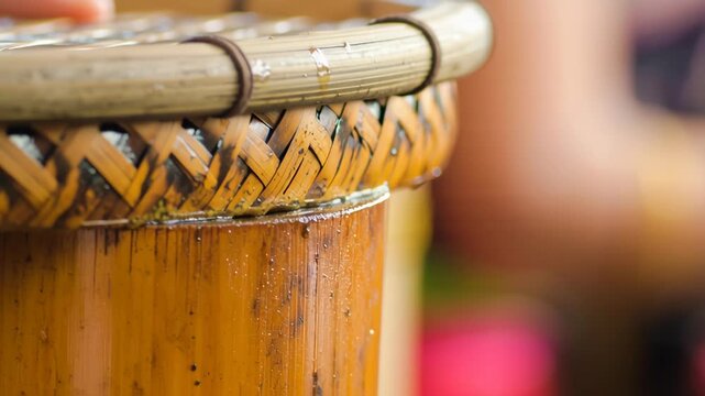 Bamboo container and woven lid for traditional rice drink in Malaysia