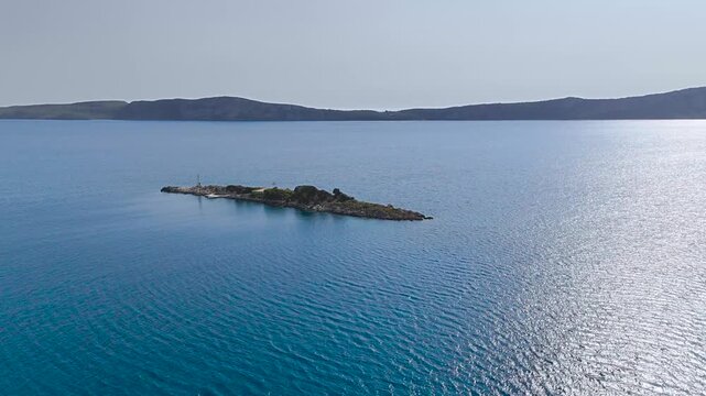 Aerial Drone View of Rocky Islet with Navigation Beacon in Clear Blue Mediterranean Sea near Gialova, Navarino Bay, Peloponnese, Greece