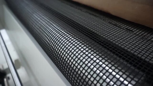 Close up of the conveyor mesh on the DTF screen printing heating machine