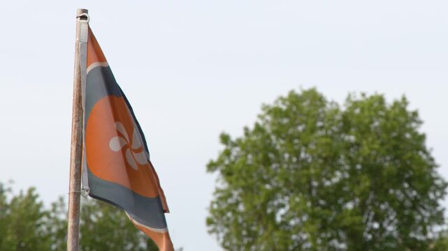 Orange and Grey Flag Waving on Metal Pole in Paris