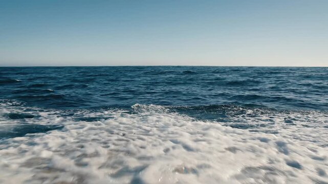 Intense POV from the bow crashing through large wave with white sea foam flooding deck.