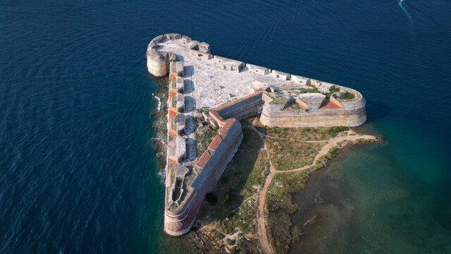Aerial view of St. Nicholas' Fortress, a triangular stone fortification surrounded by the deep blue waters of the Adriatic Sea in Sibenik, Croatia.