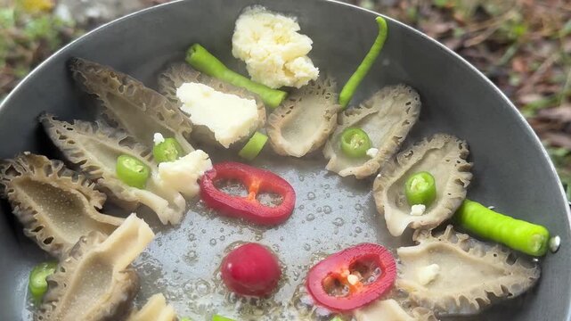 Cooking Organic Morel Mushrooms on an Open Fire in the Wilderness