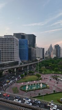 Bangkok, Thailand :Dramatic panoramic footage of sunset over Lumphini park in downtown Bangkok by Silom with BTS train riding above the busy street in the heart of Thailand capital city
