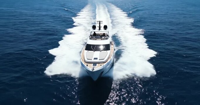 Luxury yacht sailing on ocean.