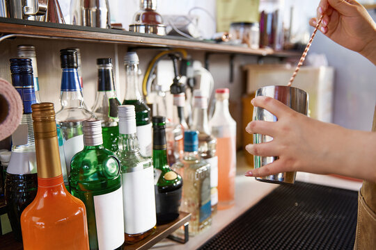 Asian women handcrafting cocktails at a caf&eacute; bar