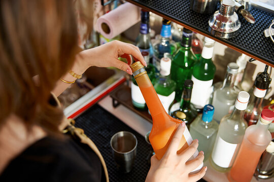 Asian women handcrafting cocktails at a caf&eacute; bar