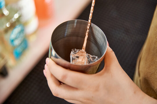 Asian women handcrafting cocktails at a caf&eacute; bar