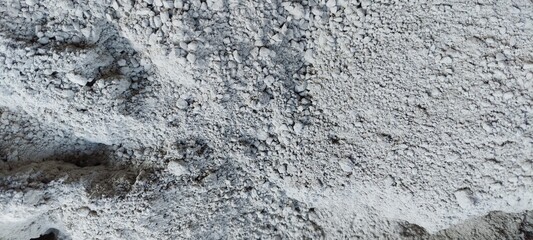 Close up of gray rocky surface with rugged texture © ezraceavi