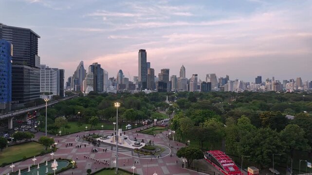 Bangkok, Thailand: Panoramic footage of sunset over Lumphini park in downtown Bangkok by Silom with BTS track above the busy street in the heart of Thailand capital city