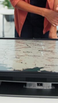 Hands, screen or meeting with map for environmental project or climate change in office. Group, people or business discussion with geographic display or location for eco development, idea or planning