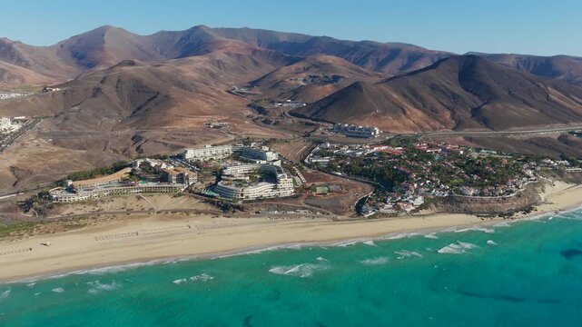 Aerial view of luxury beachfront resort architecture, swimming pools and sun loungers in Morro Jable Fuerteventura