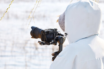 Cameraman using handheld camera gimbal stabilizer for outdoor video shooting © 亮亮 徐