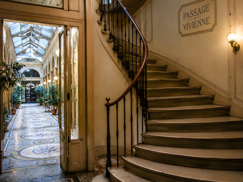 Historic interior staircase Parisian building ornate architectural hallway vintage European passageway, elegant spiral stair design, antique residential corridor with decorative railings, patterned fl