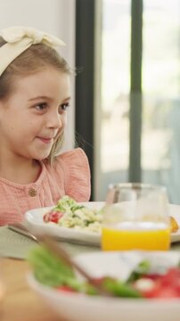 Lunch, parent and playful with child at table for teasing, healthy meal or pinch cheeks for bonding. Food, family or playing with girl at brunch for affection, relationship or love expression in home