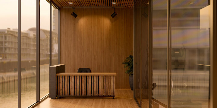 Wooden reception counter front desk table on parquet floor beside glass wall in a modern office room